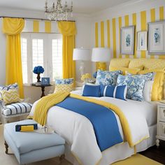 a bedroom decorated in yellow and blue