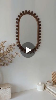 a mirror hanging on the wall above a dresser