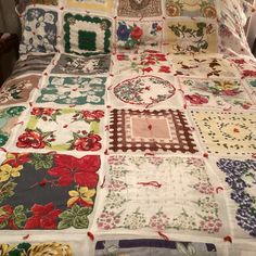 a bed covered in lots of different types of quilts