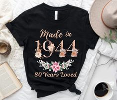 a black shirt that says made in 1994 and has flowers on it