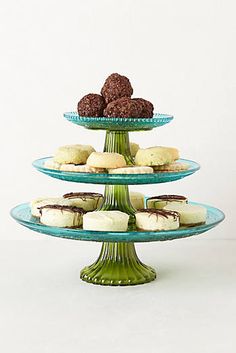 three tiered trays with cookies and pastries on them in front of a white background