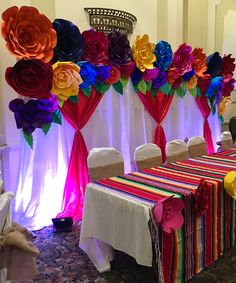 the table is decorated with colorful paper flowers