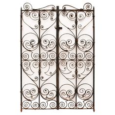 an iron gate with swirly designs on the top and bottom bars, set against a white background