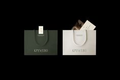 two shopping bags with white handles on black background