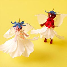 two plastic figurines are standing next to each other on a bright yellow background