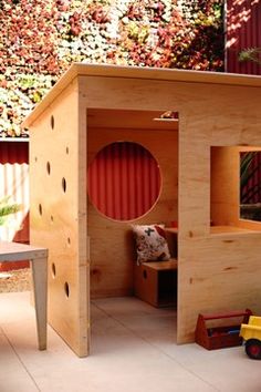 a child's play house made out of plywood