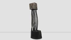 a tall wooden object with black metal rods sticking out of it's sides, on a gray background