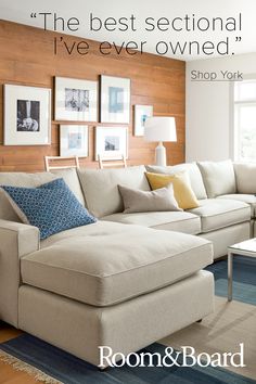 a living room filled with furniture and pictures on the wall