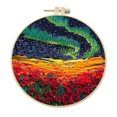 the aurora bore is in the sky over a field of red flowers and green grass