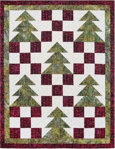 a red and white quilt with trees on it