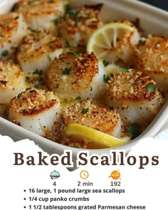 baked scallops in a baking dish with lemon wedges and parmesan cheese