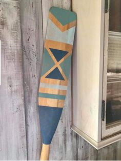 a surfboard hanging on the side of a wooden wall next to a door way