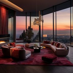 a living room filled with lots of furniture next to tall windows at sunset or dawn