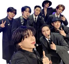 a group of young men in suits and hats posing for a photo with one finger up