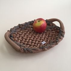 an apple sitting on top of a woven basket