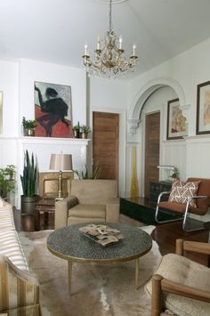 a living room filled with furniture and a chandelier