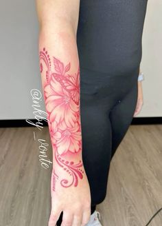 a woman's arm with pink flowers on it