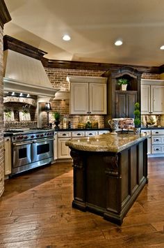 a large kitchen with an island in the middle and lots of cabinets on both sides