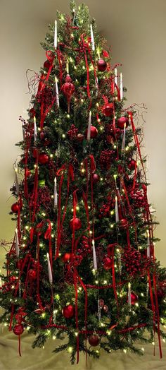 a decorated christmas tree with candles and ornaments