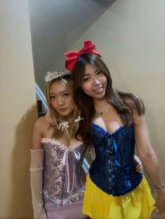 two young women dressed in costumes posing for the camera