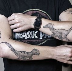 two men with tattoos on their arms holding each other