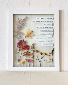 a white frame with flowers and words on it