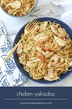 two bowls filled with chicken and noodles on top of a white table cloth next to a fork