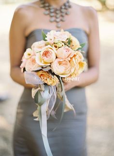 a woman holding a bouquet of flowers in her hand