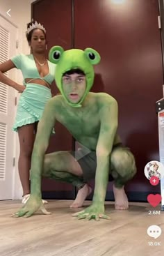 a man in a frog costume poses with a woman