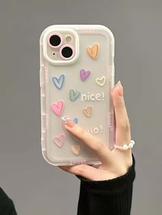 a woman holding up a phone case with hearts on it and the words nice written in white