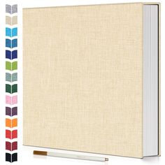 a blank book with colored stripes and a pen next to it on a white background