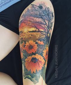 sunflowers on the arm with trees and mountains in the background by tattoomag