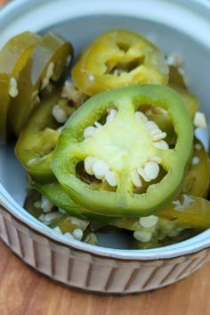 some green peppers are in a bowl on a table