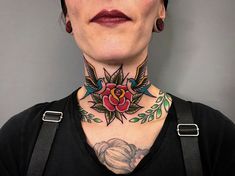 a woman with tattoos on her neck and chest