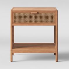 the side table is made out of wood and has a rattan pattern on it