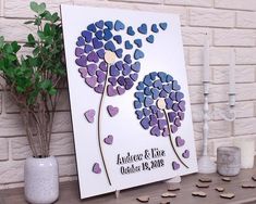 a wedding card with purple and blue hearts on it next to a potted plant