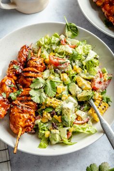 a white plate topped with chicken and salad