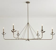 a chandelier hanging from the ceiling in a room with white walls and flooring