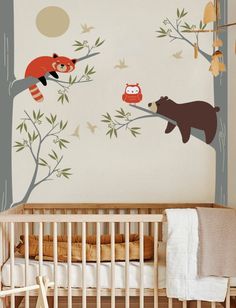 a baby's room with wall decals and a crib