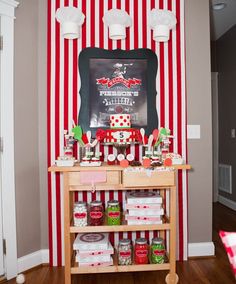 a candy bar is decorated with red and white striped wallpaper, an chalkboard on the wall