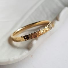 a close up of a gold ring on a white surface