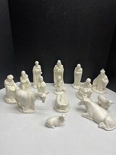 seven white porcelain figurines of people and animals