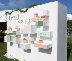 there is a sign that says treat shoppe on the side of it and some shelves with food in them