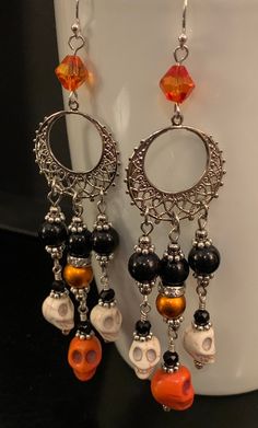 the earrings are decorated with skulls and beads