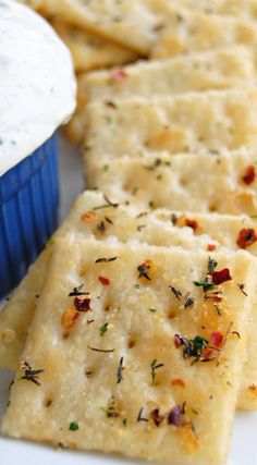 crackers and dip on a white plate with blue cupcake in the back ground