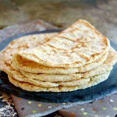 a stack of tortillas sitting on top of a blue plate