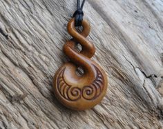 a wooden necklace with an intricate design on it