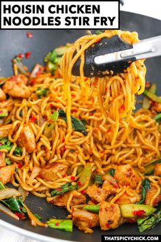 chicken noodle stir fry in a wok with chopsticks lifting up noodles