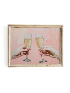 two hands holding champagne glasses in front of a pink background with the image on it