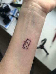 a person with a small tattoo on their wrist